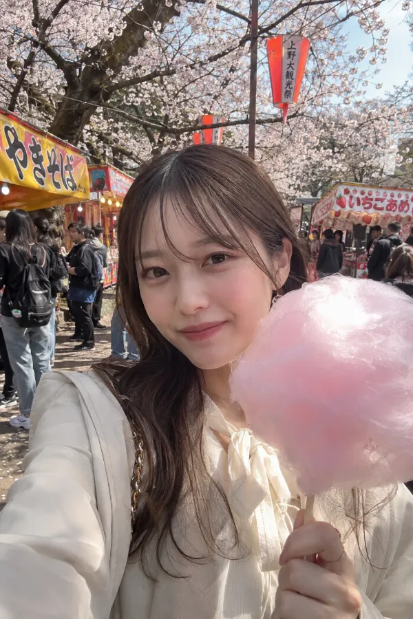春のお花見。満開の桜、屋台、わたあめが並ぶ公園の実写プロンプト作例。